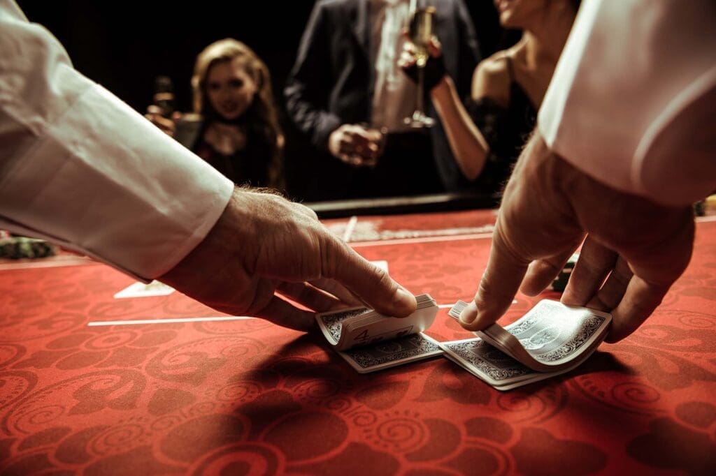 Image of casino dealer shuffling cards in hands.